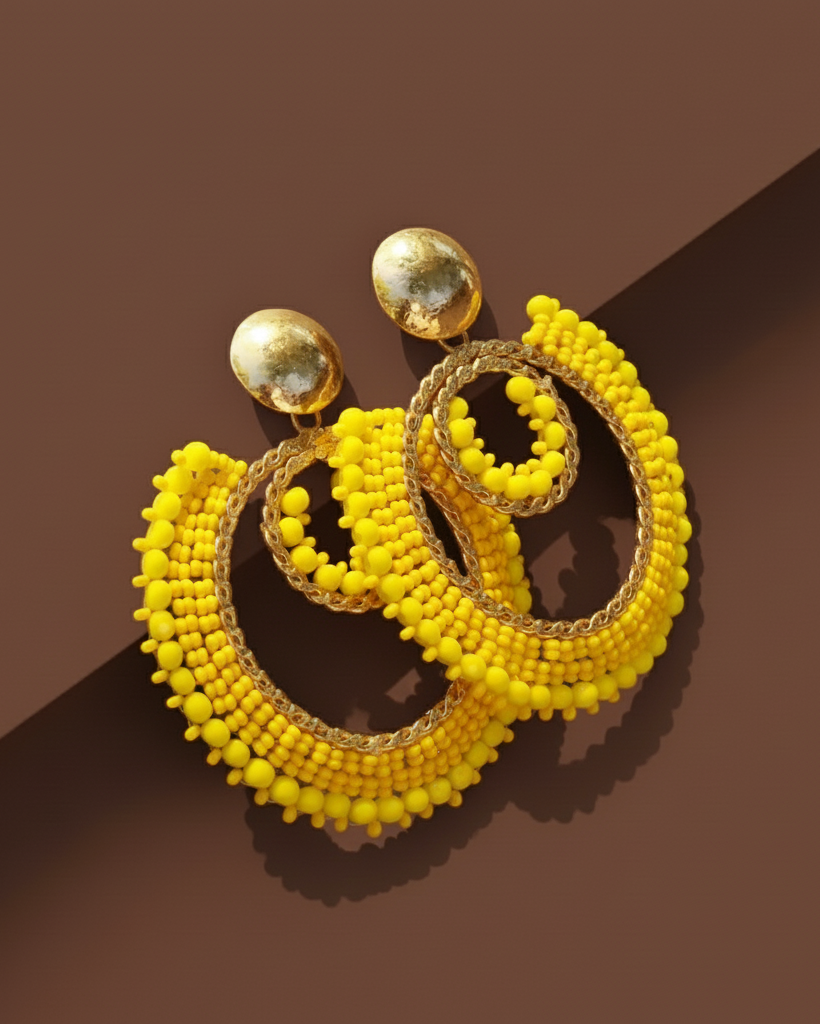 Big Round Yellow beaded Kawami earrings on a brown background
