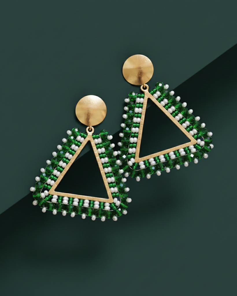 Triangular Kawamii earrings with green and white bead details on a dark background