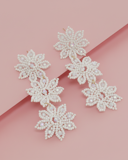 3 Star-Shaped in Pearl color Kawami earrings on a pink background