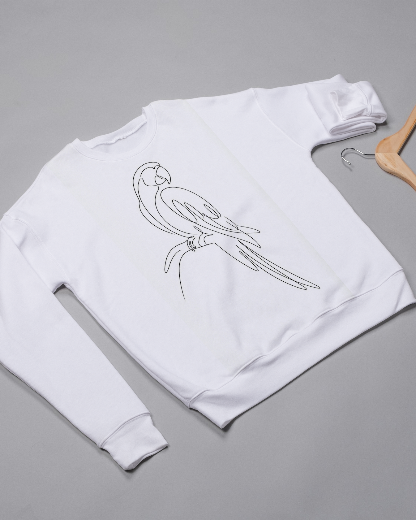 White sweatshirt with a parrot design on a gray background