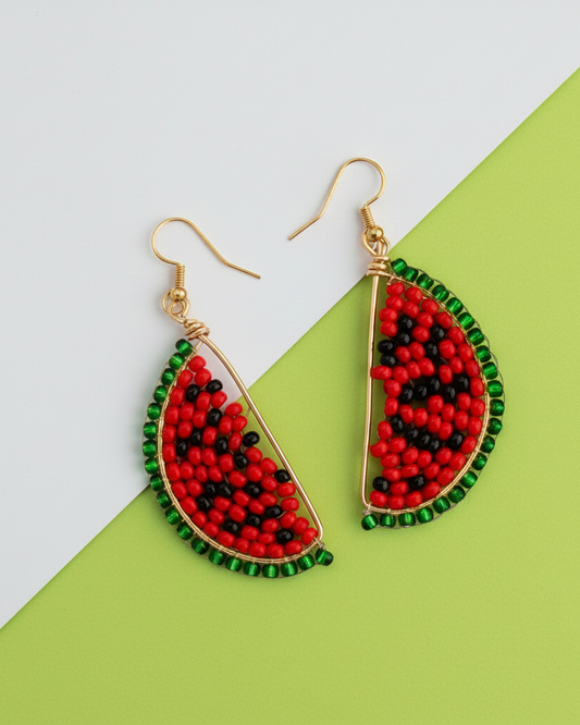 Kawami Beaded watermelon slice earrings on a green and white background
